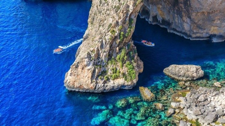 Tourist boats seen at the famous Blue Grotto in Malta.