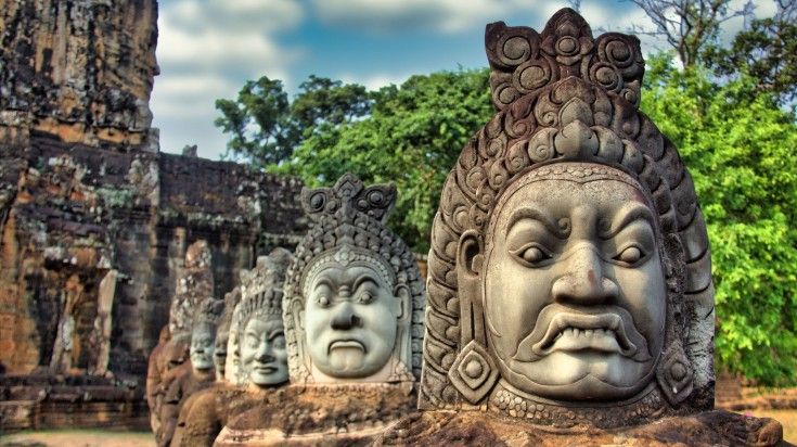 You can find ancient statues in Cambodia during a hiking trip. Closeup view of statues at the Angkor Wat in Cambodia.