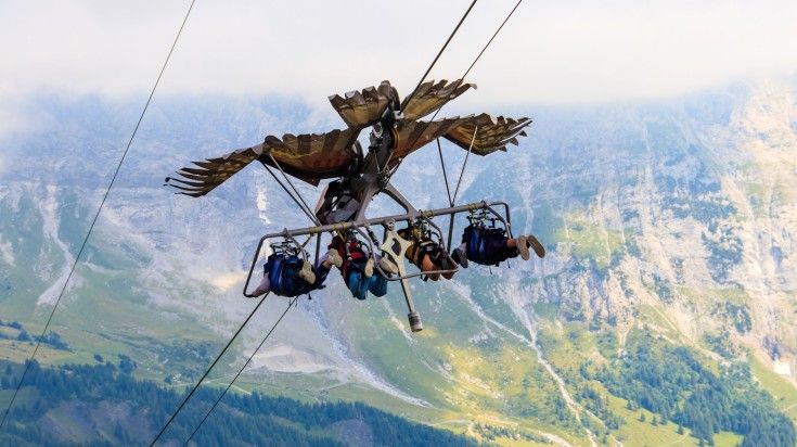 4 tourists trying gliding at Grindelwald.