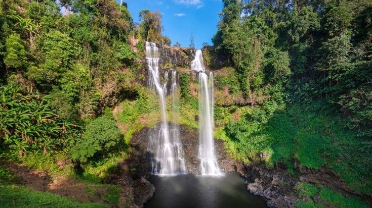 A view of Tad Yuang waterfall, which is hidden among lush rainforest in the Bolaven Plateau, in southern Laos. Visit waterfalls like Tad Yuang during the tour of Bolaven Plateau in Laos.