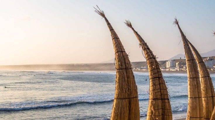 Huanchaco Beach and the traditional reed boats in Peru. Huanchaco Beach and the traditional reed boats in Peru.