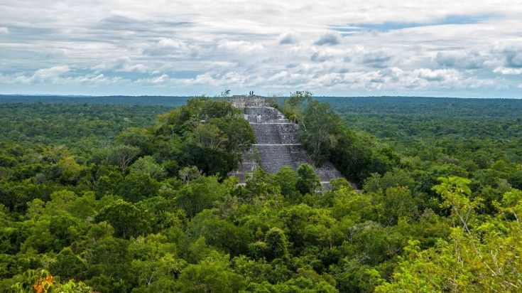 Calakmul pyramids among trees in Campeche on a cloudy day in Mexico. Calakmul pyramids among trees in Campeche on a cloudy day in Mexico.