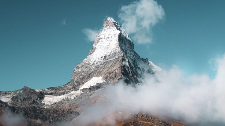 A view of Matterhorn with clouds around it.
