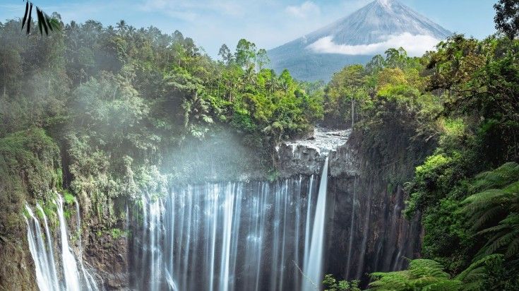 A view of Tumpak Sewu Waterfall on a clear day in Indonesia.