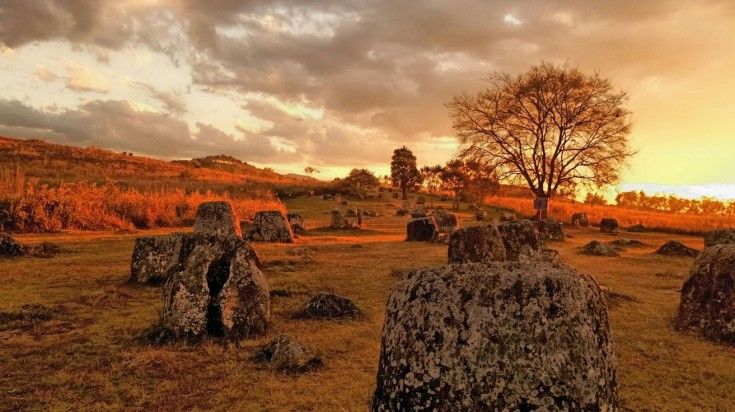 A sunset view of Plain of Jars, a megalithic archaeological site in Phonsavan, Laos. An archaeological site known as the Plain of Jars in Phonsavan, Laos.