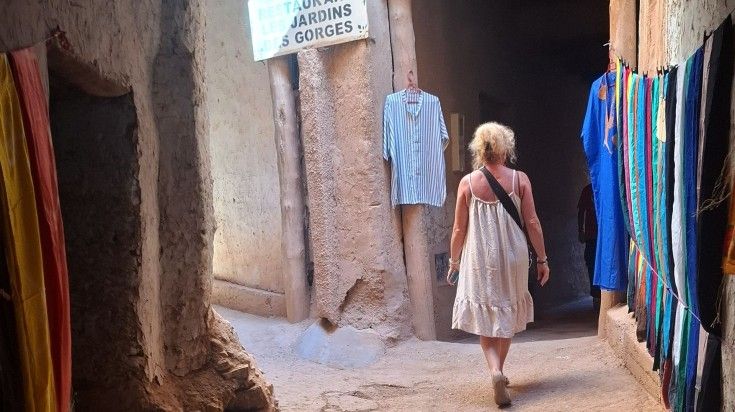An elderly traveler walks through the alleys of Morocco