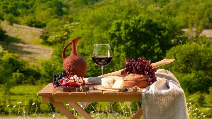 A board set up for Georgian wine tasting in a vieyard. A board set up for Georgian wine tasting in a vieyard.
