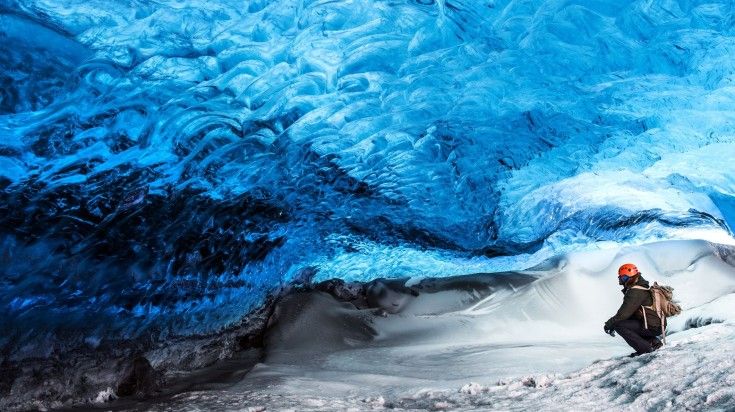 A man ice caving in Skaftafell National Park. A man ice caving in Skaftafell National Park.