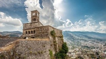 Built in 12th Century CE, Gjirokastra Castle is perched high on top of a hillside overlooking the town below on one side and a glorious view of the mountains to the other. Gjirokastra Castle overlooks the town below in Albania
