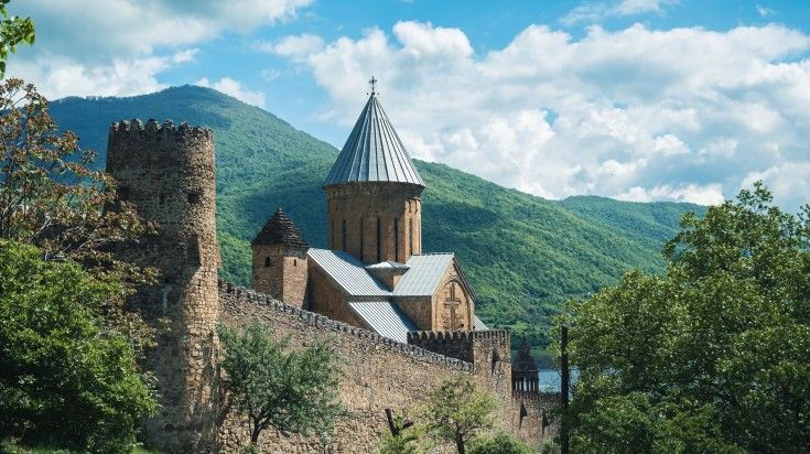 The view of Ananuri Castle on a cloudy day by the river during your 6 days in Georgia. The view of Ananuri Castle on a cloudy day by the river during your 6 days
