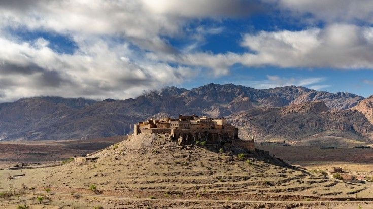 A scenic view of Morocco's Altas mountains, with Kasbah Tizourgane on the s