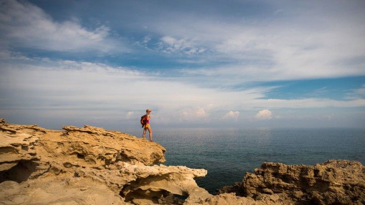 Hiker looking at the Blue Lagoon in Cyrus, one of the best places to visit.