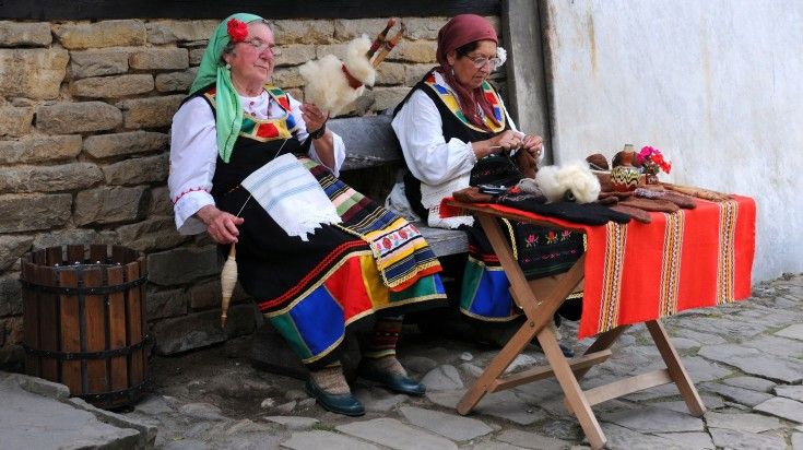 Bulgarian women spin and knit outside their house in Etara.