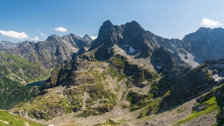 The view of Morskie Oko and peaks of High Tatras Mountain on a clear day.