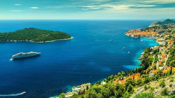 Set sail on a luxurious Dubrovnik cruise and immerse yourself in stunning coastal views, elegant amenities, and unforgettable experiences on the sparkling Adriatic Sea. Panoramic view of a cruise heading towards Dubrovnik in Croatia.