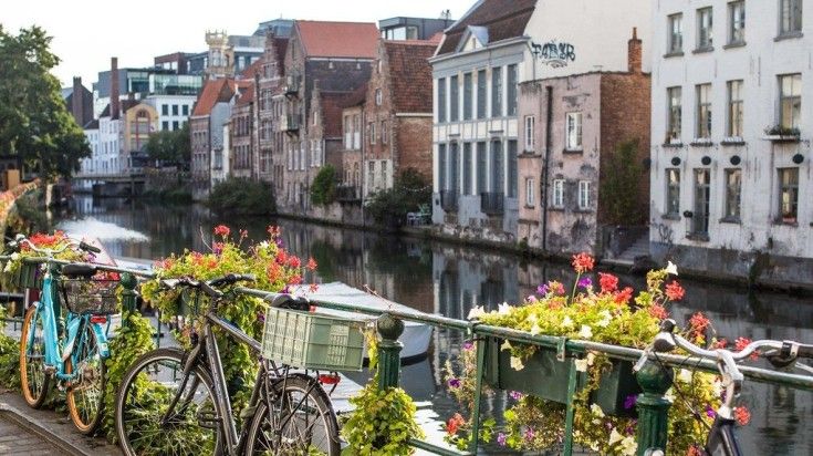 Cycles parked near a canal in Ghent.