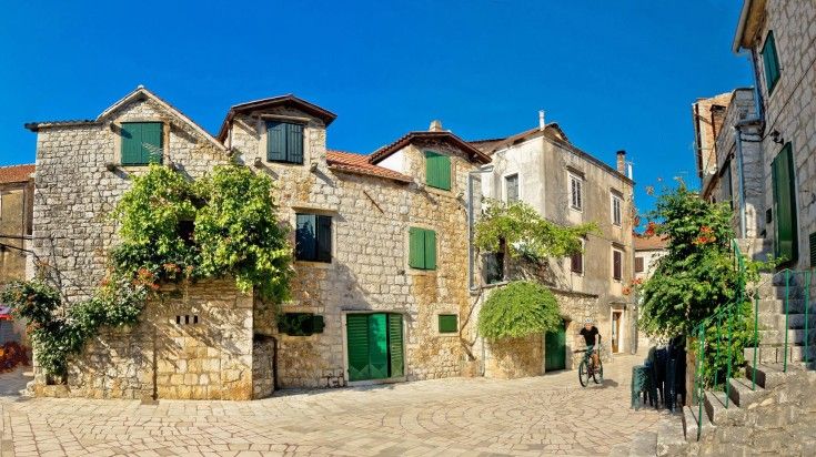 A tourist cycling in Hvar Island on a clear day.