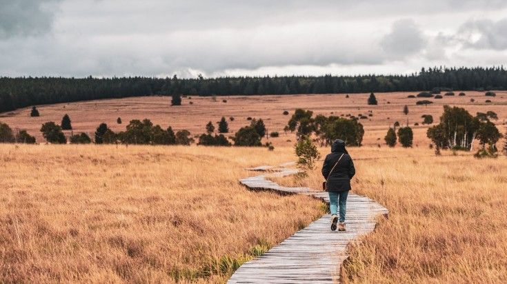 A tourist walking a trail at High Fens Nature Park.