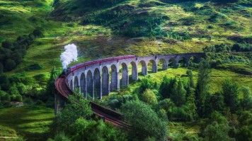 The Glenfinnan Railway Viaduct is famously featured in the Harry Potter films as the Hogwarts Express crosses it. The Glenfinnan Railway in Scotland with the Jacobite steam train