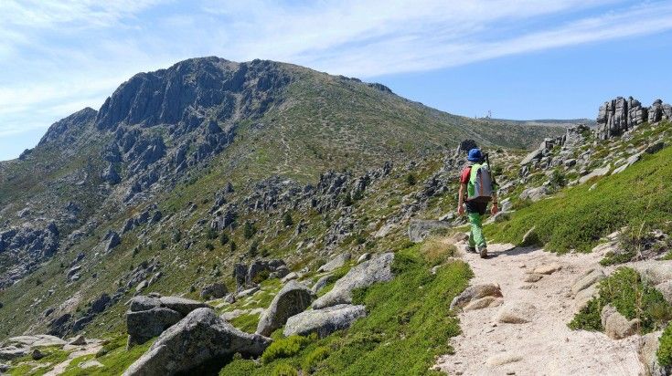 A man hiking in Messaria on a clear day in Greece.