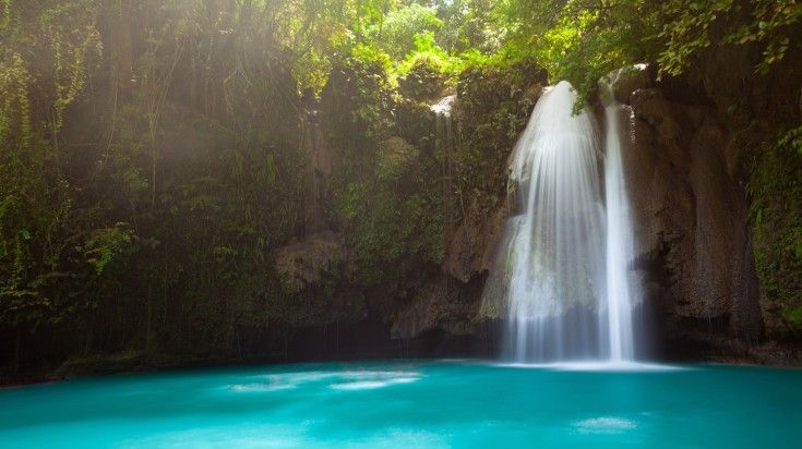 Incredible turquoise Kawasan waterfalls located on Cebu Island, Philippines.