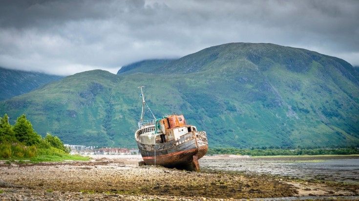 The Old Boat of Caol, commonly referred to as the Corpach shipwreck, is among Scotland's most photographed wrecks. The Corpach Wreck, an old shipwreck resting on the rocky shoreline.
