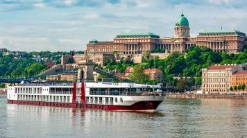 The Danube stretches over 2,850 km, flowing through 10 countries, including Germany, Austria, Slovakia, Hungary, and Romania. A cruise ship sailing along the Danube River in Budapest, Hungary.