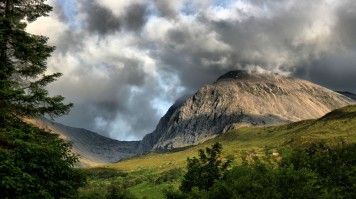 Ben Nevis is Scotland's highest mountain, towers impressively at 4,413 feet. View of Ben Nevis surrounded by clouds.