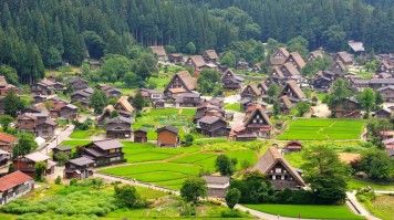 A village of traditional thatched-roof houses in Shirakawago in Japan