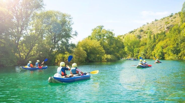Group of kayakers in Croatia during evening.