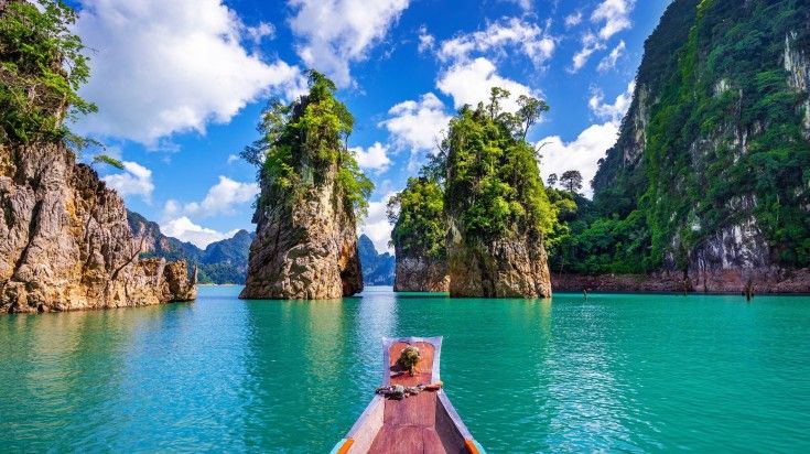 Beautiful mountains with a boat at Khao Sok National Park on a clear day.