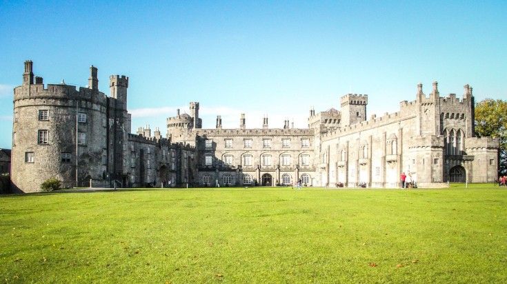 The front view of Kilkenny Castle on a bright sunny day in Ireland.