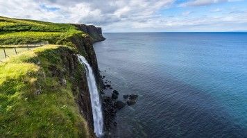 Kilt Rock is a striking geological formation on the Isle of Skye, Scotland, featuring dramatic basalt columns and a spectacular waterfall cascading down its cliffs. Kilt Rock and Mealt Waterfall, a famous landmark on the Isle of Scotland