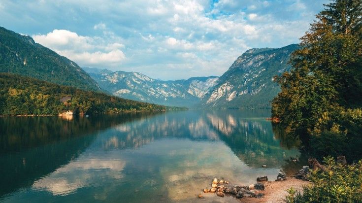 Lake Bohinj surrounded with Julian Alps mountains on a cloudy day in Sloven