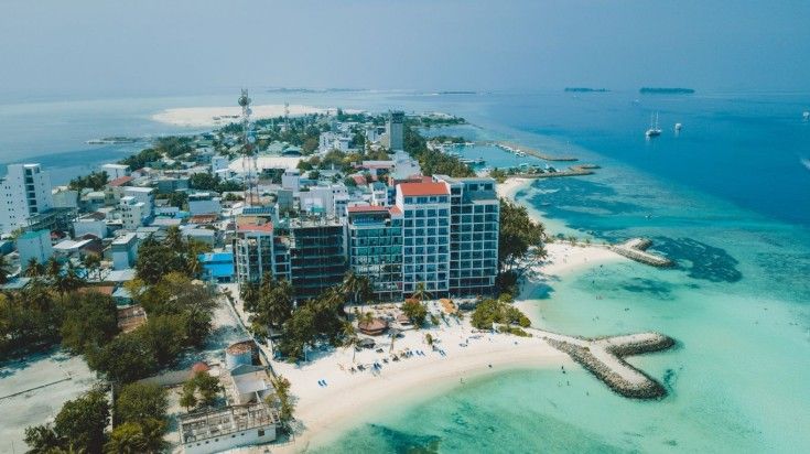 Aerial view of Maafushi Island on a clear day in the Maldives.