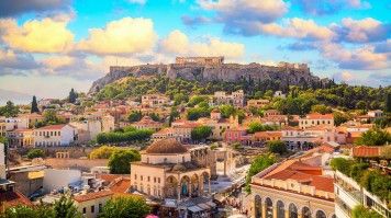 Skyline of Athens with Monastiraki Sqaure and Acropolis Hill during sunset.