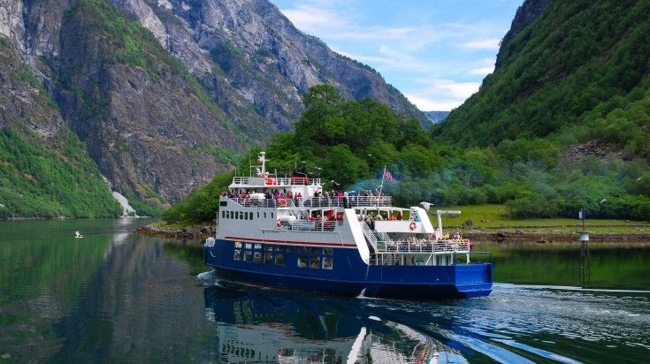A cruise sailing through Naeoyfjord on a clear day in Norway.