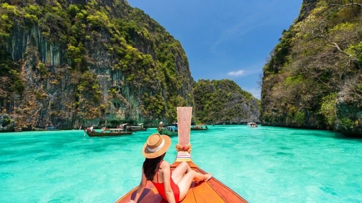 A woman relaxing on the boat in Phi Phi Island on a clear day in Thailand. A woman relaxing on the boat in Phi Phi Island on a clear day in Thailand.