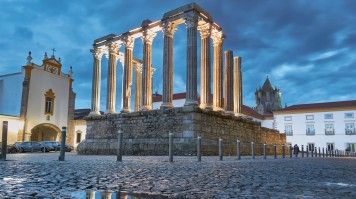 Roman ruins in Evora in Portugal in the evening