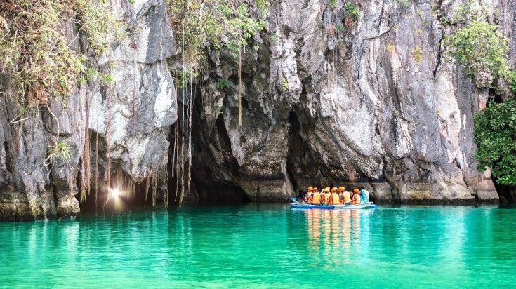 A group of people entering  the cave in Puerto Princesa River during their