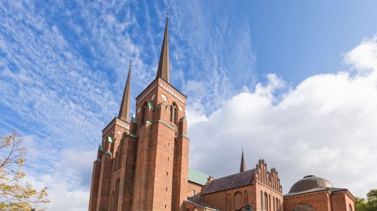 View from south-west of Roskilde Cathedral on a cloudy day in Denmark.
