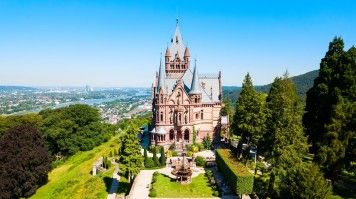 Aerial view of Schloss Drachenburg Castle on a bright sunny day.