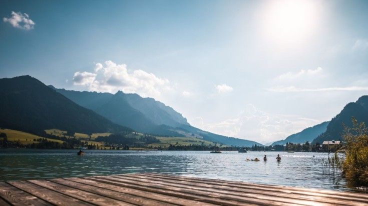 Swim in the Alpine lakes of Austria in June.