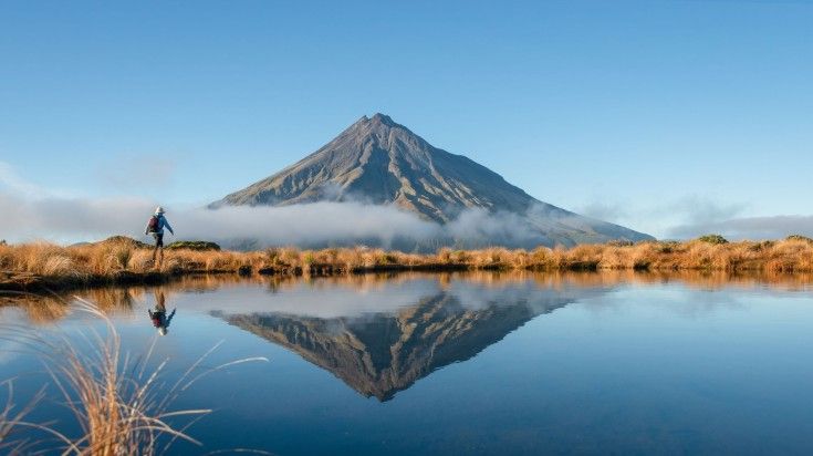 Tourist hiking Mt Taranaki when spending 21 days in New Zealand.
