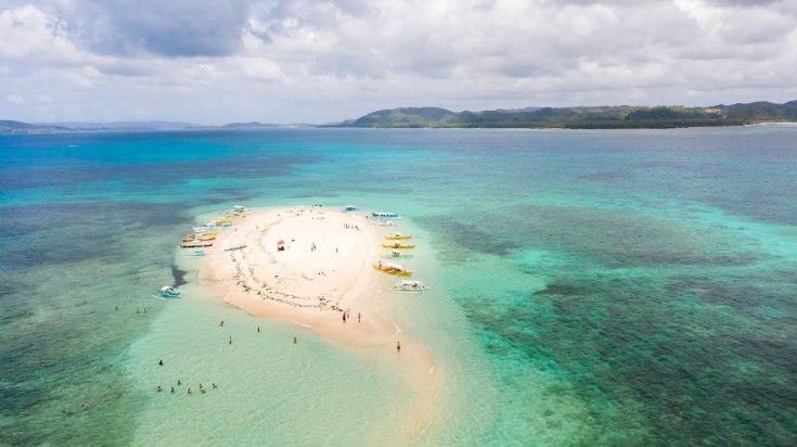 Tourists enjoying at Naked Island, Siargao.