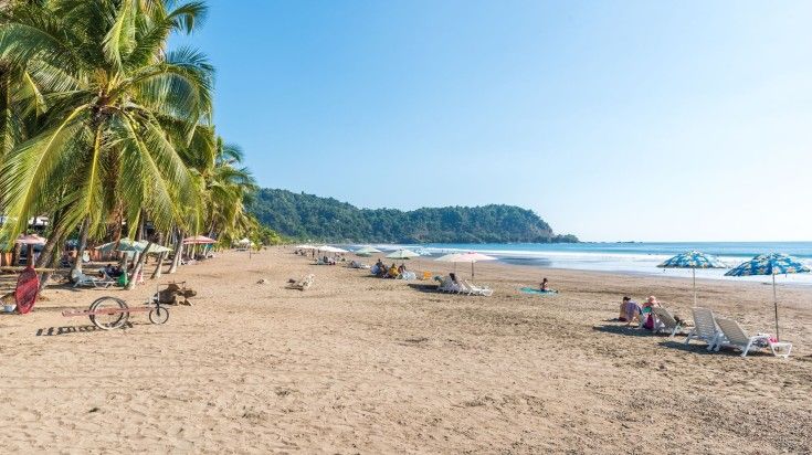 Tourists relaxing in the sandy beach of Jaco. Tourists relaxing in the sandy beach of Jaco.