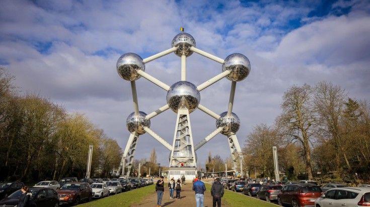 Tourists walking towards The Atomium of Brussels.