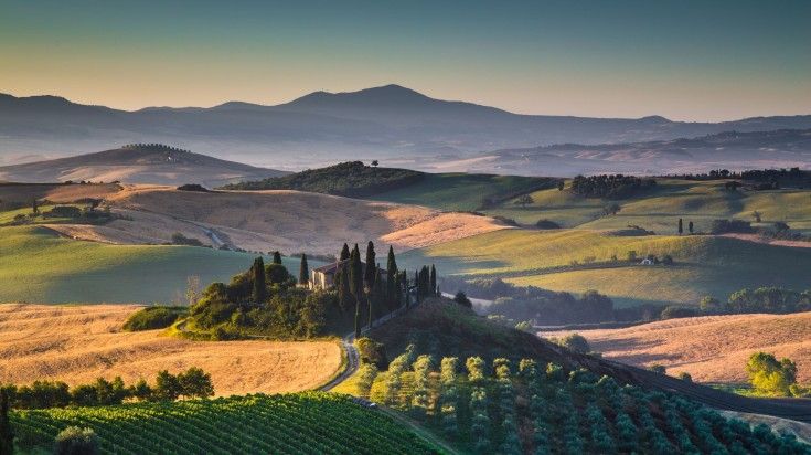 Scenic Tuscany landscape with rolling hills and valleys in golden morning l