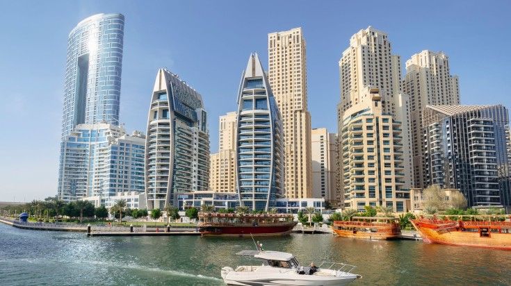 View of skyscrapers as seen from Dubai Marina on a yacht. View of skyscrapers as seen from Dubai Marina on a yacht.