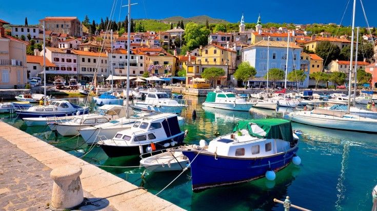 Idyllic waterfront with boats in Volosko village on a clear day in Croatia. Idyllic waterfront with boats in Volosko village on a clear day in Croatia.